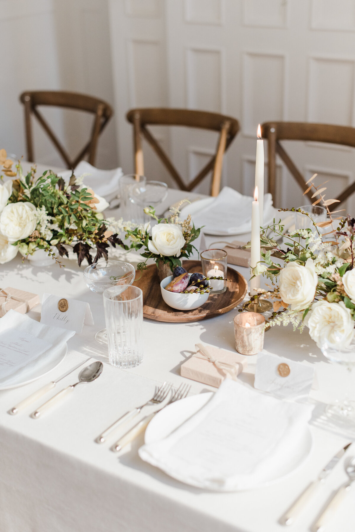 a table with a white table cloth and flowers on it