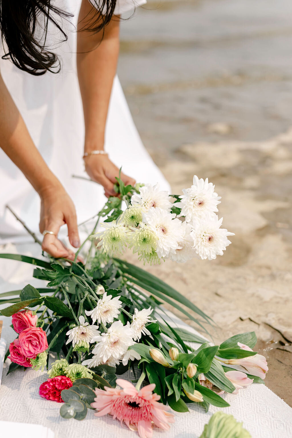 Woman Arranging Bouquet of Flowers