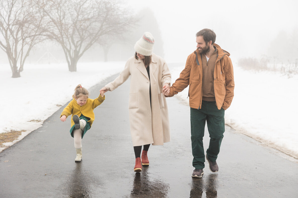 Parents walking with their little girl