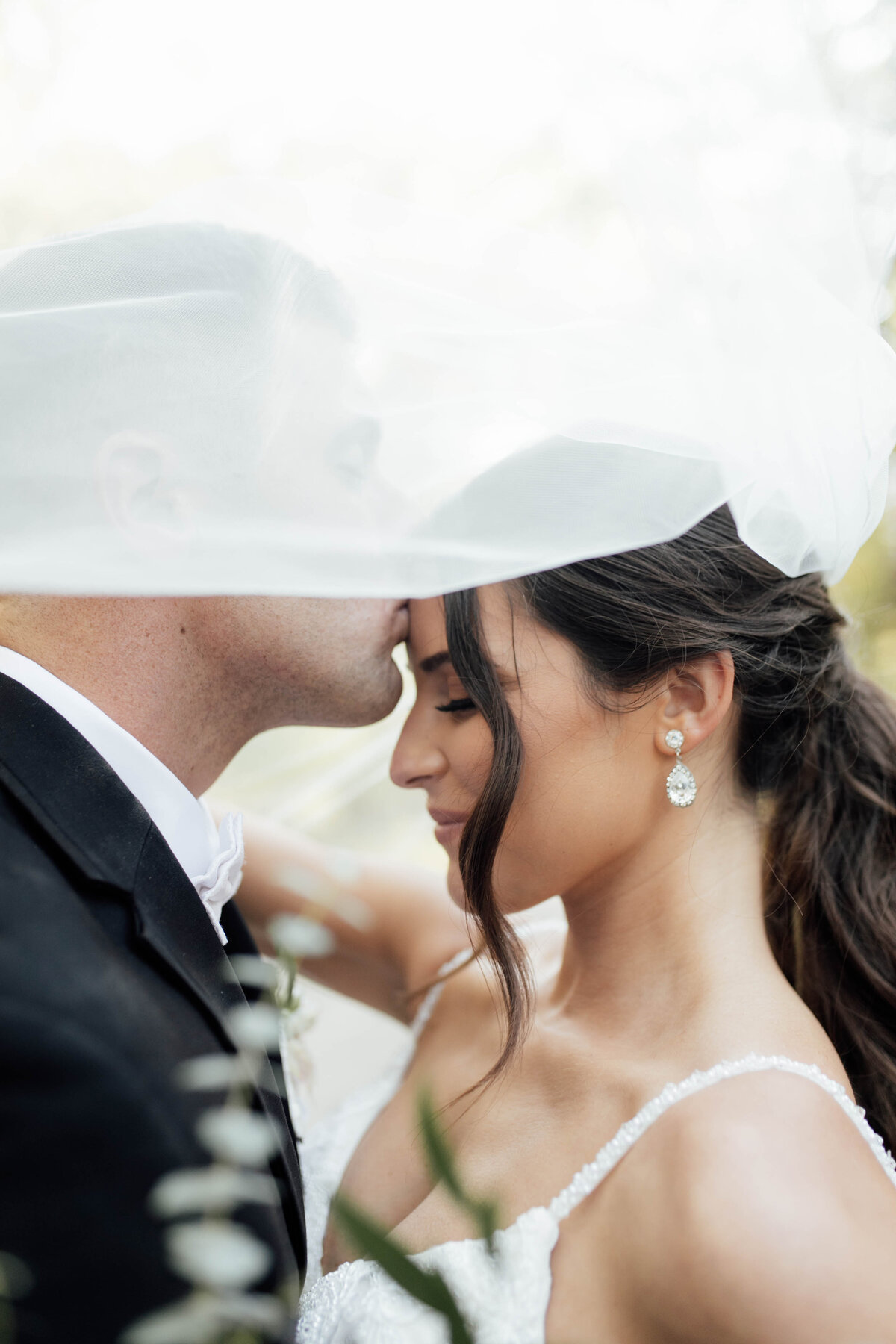 Bride and groom sharing an intimate moment. 