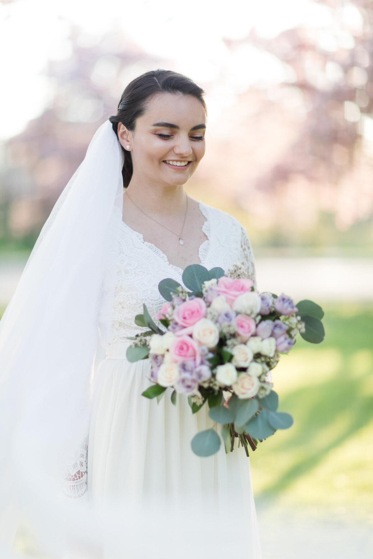 Experience the radiance of joy in Taylor's portrait, expertly captured by Ottawa Wedding Photographer, Lauren Duffy. With a smile that illuminates the frame, Taylor stands adorned in a flowing veil, gracefully reaching into the foreground alongside her carefully held bridal bouquet. Lauren Duffy Photography beautifully freezes this moment of pure bliss, where love, laughter, and elegance converge. Cherish the artistry of Ottawa's premier wedding photographer, as each frame becomes a testament to the joy and beauty found in the union of love and celebration. Let Lauren Duffy Photography tell your love story with style and sophistication.