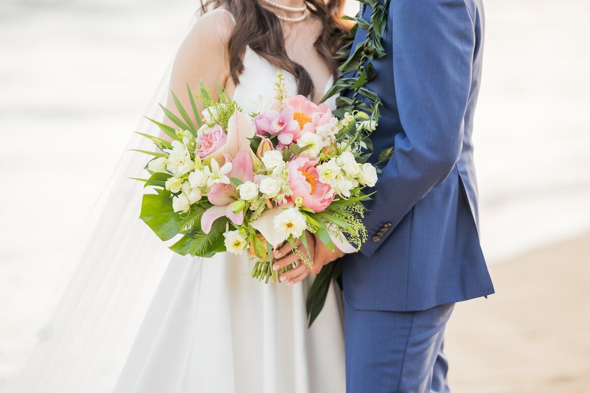 photo of Maui wedding bouquet details with bride and groom