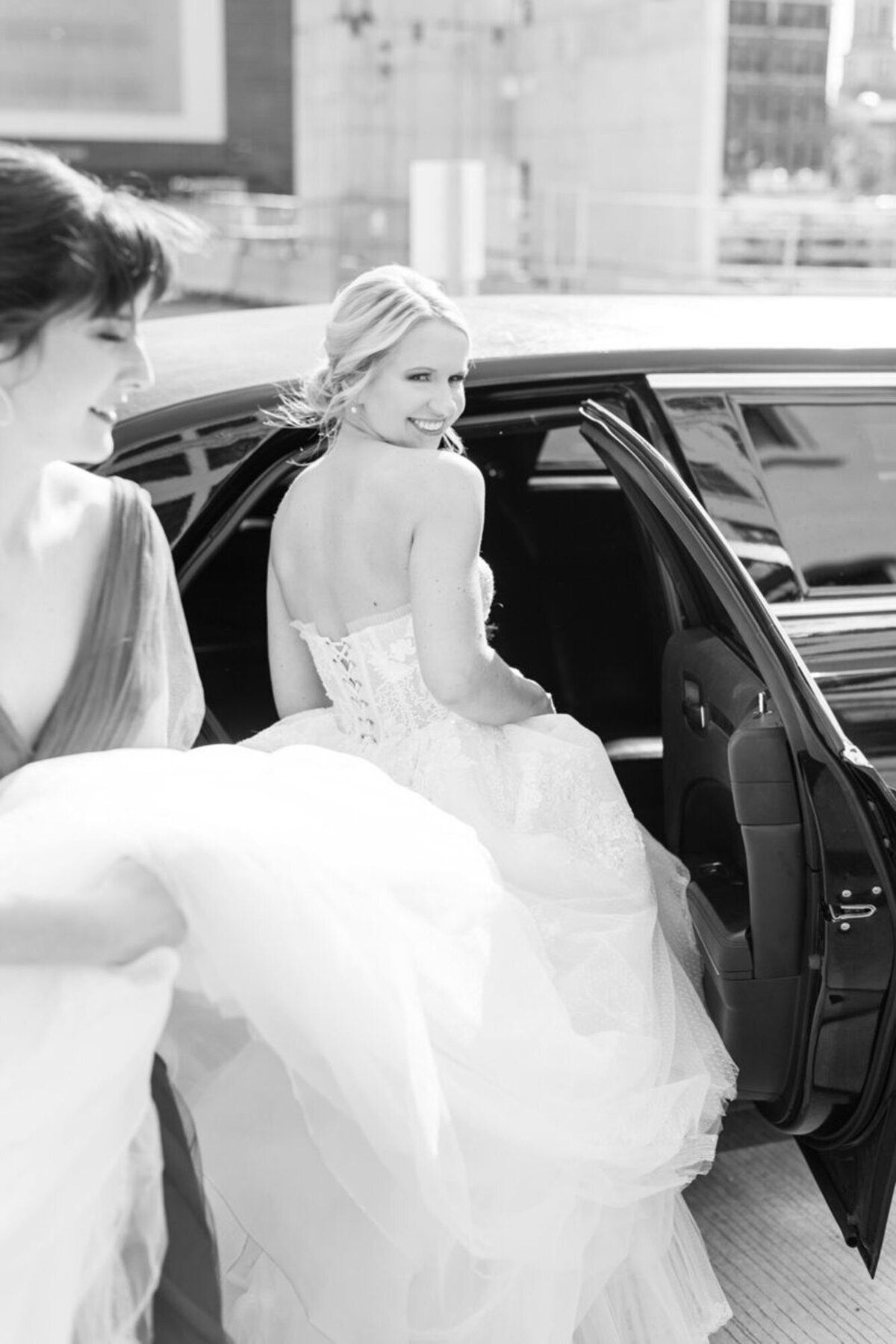 Bride getting into car taken by Courtney Rudicel, wedding photographer in Cincinnati, OH

