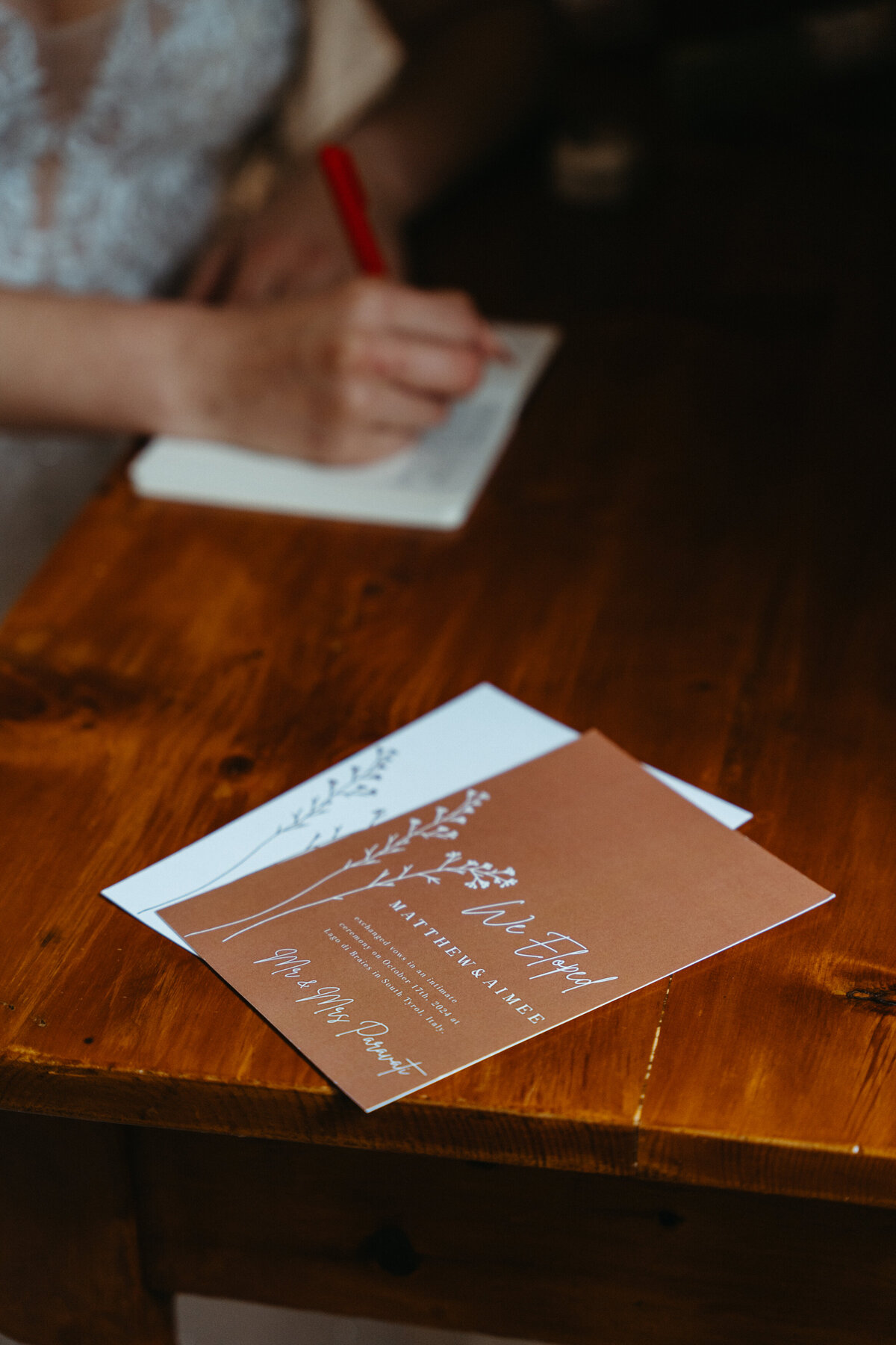 Wedding vows placed on wooden table with floral design
