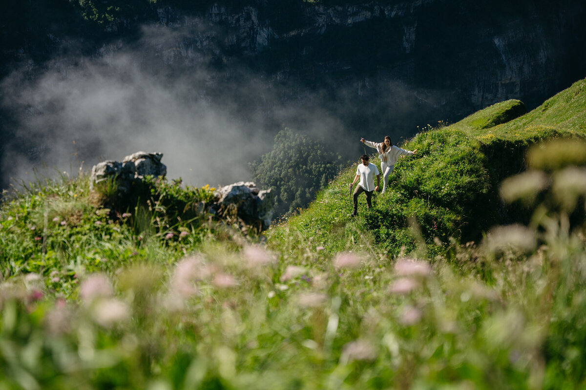 Couple hiking through Appenzell with wildflowers