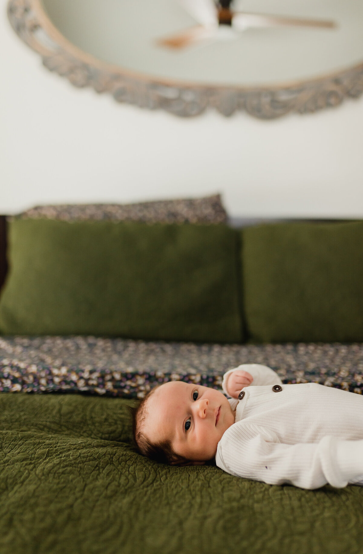 Newborn photography with a newborn lays on big bed