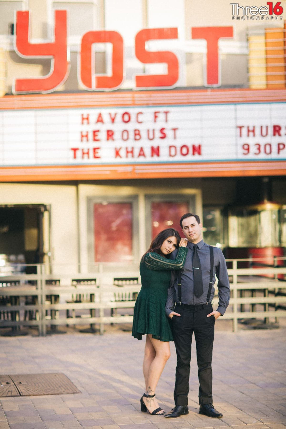 Bride to be rests her head on her Groom's shoulder while standing in front of the Yost Theater in Santa Ana