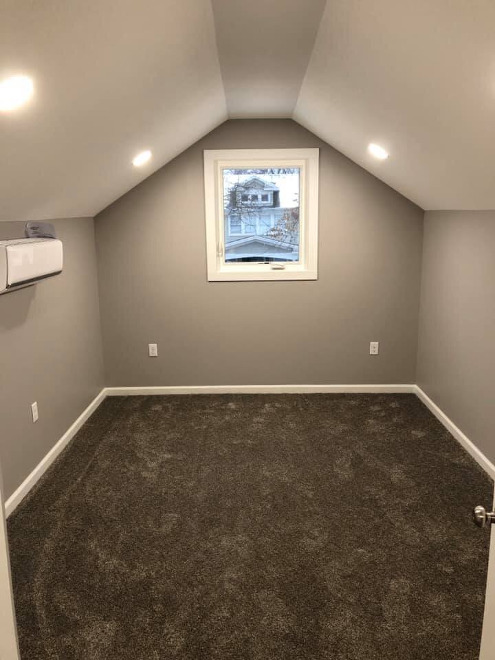 Room with grey walls and carpeting
