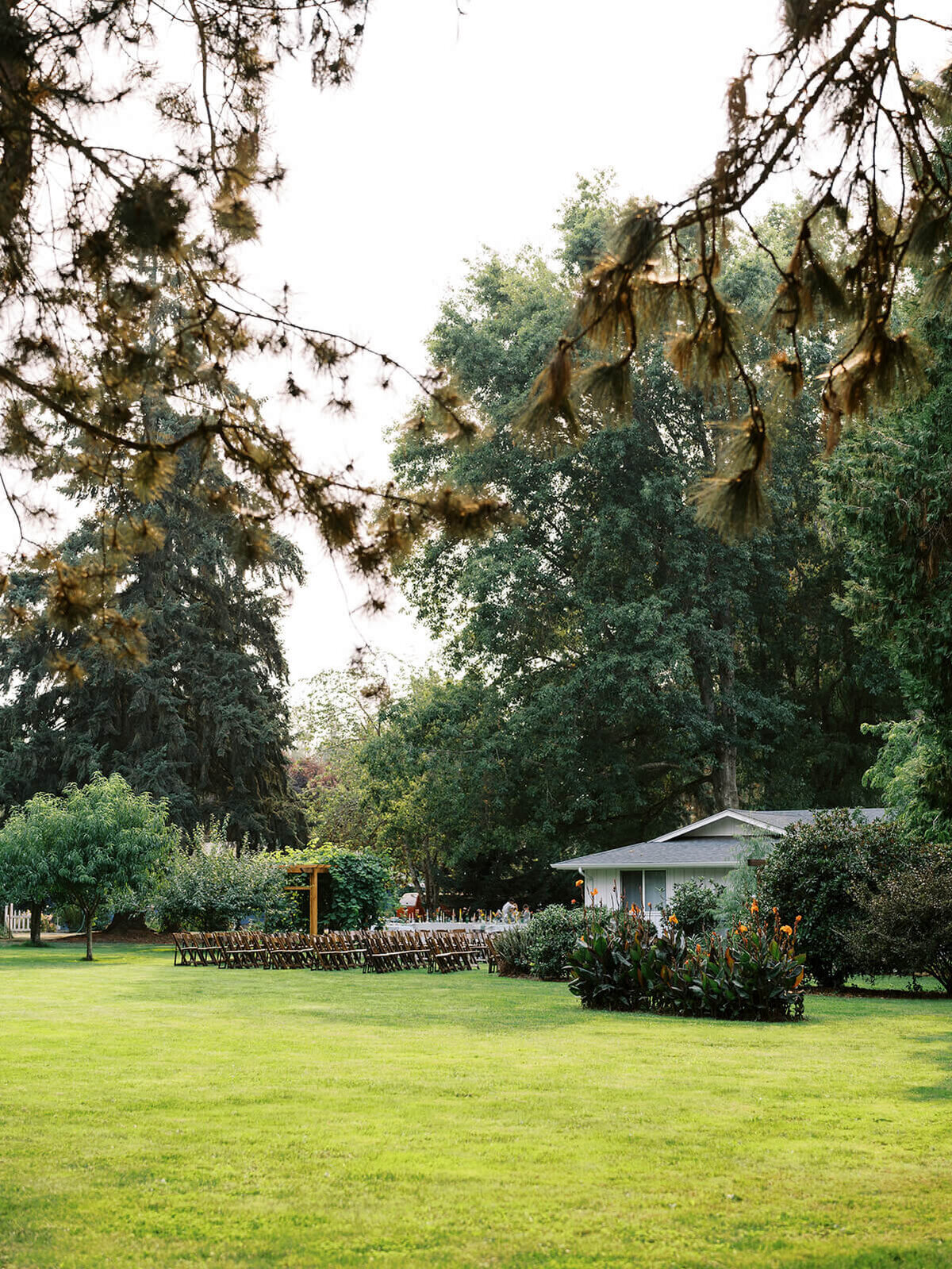Backyard wedding ceremony all set up with chairs captured from a distance. 