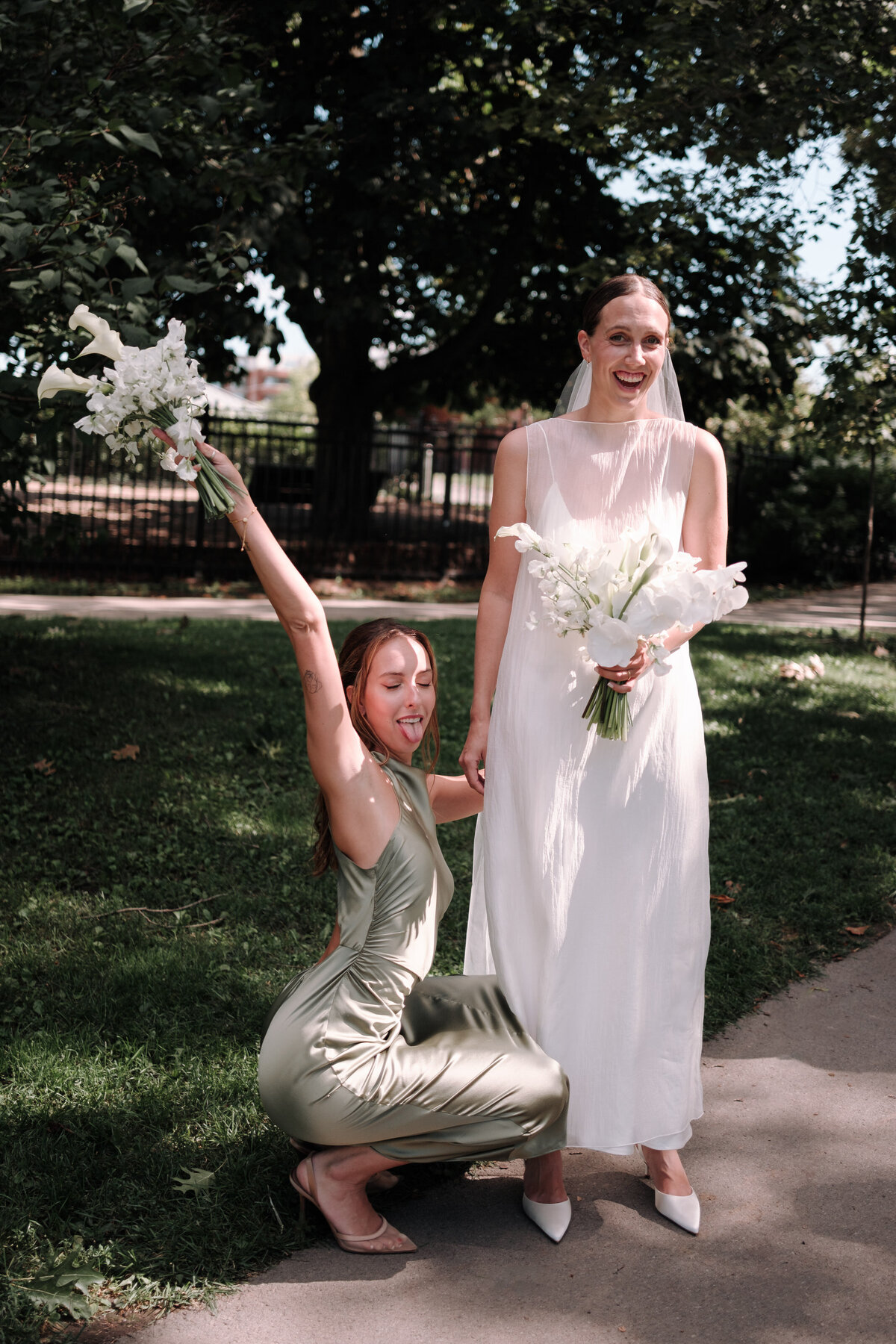 sisters sharing a fun moments at brides wedding