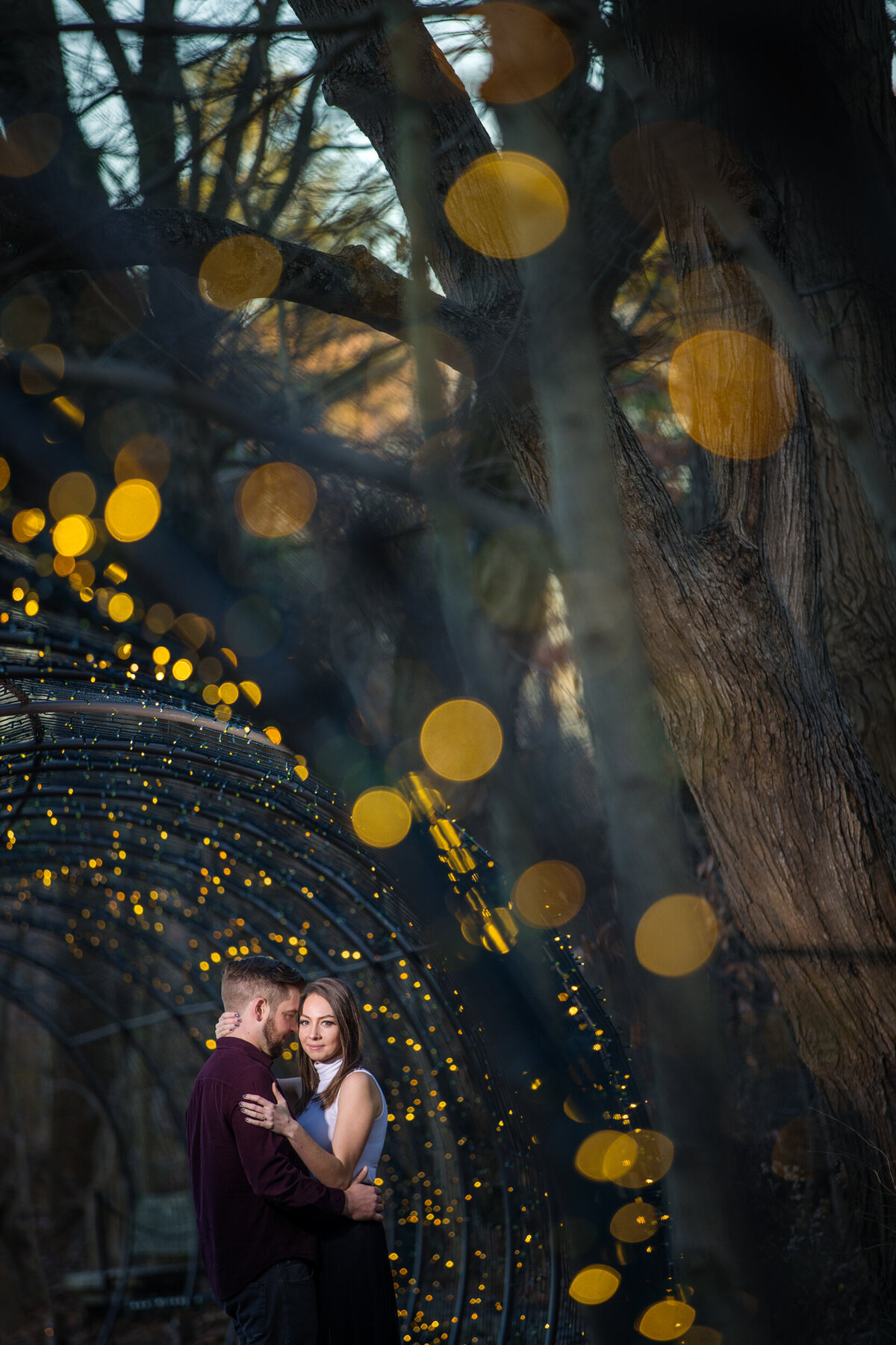 Captivating dusk-time engagement photo of a couple in Longwood Gardens, framed by soft evening light and a tranquil, dreamy atmosphere.