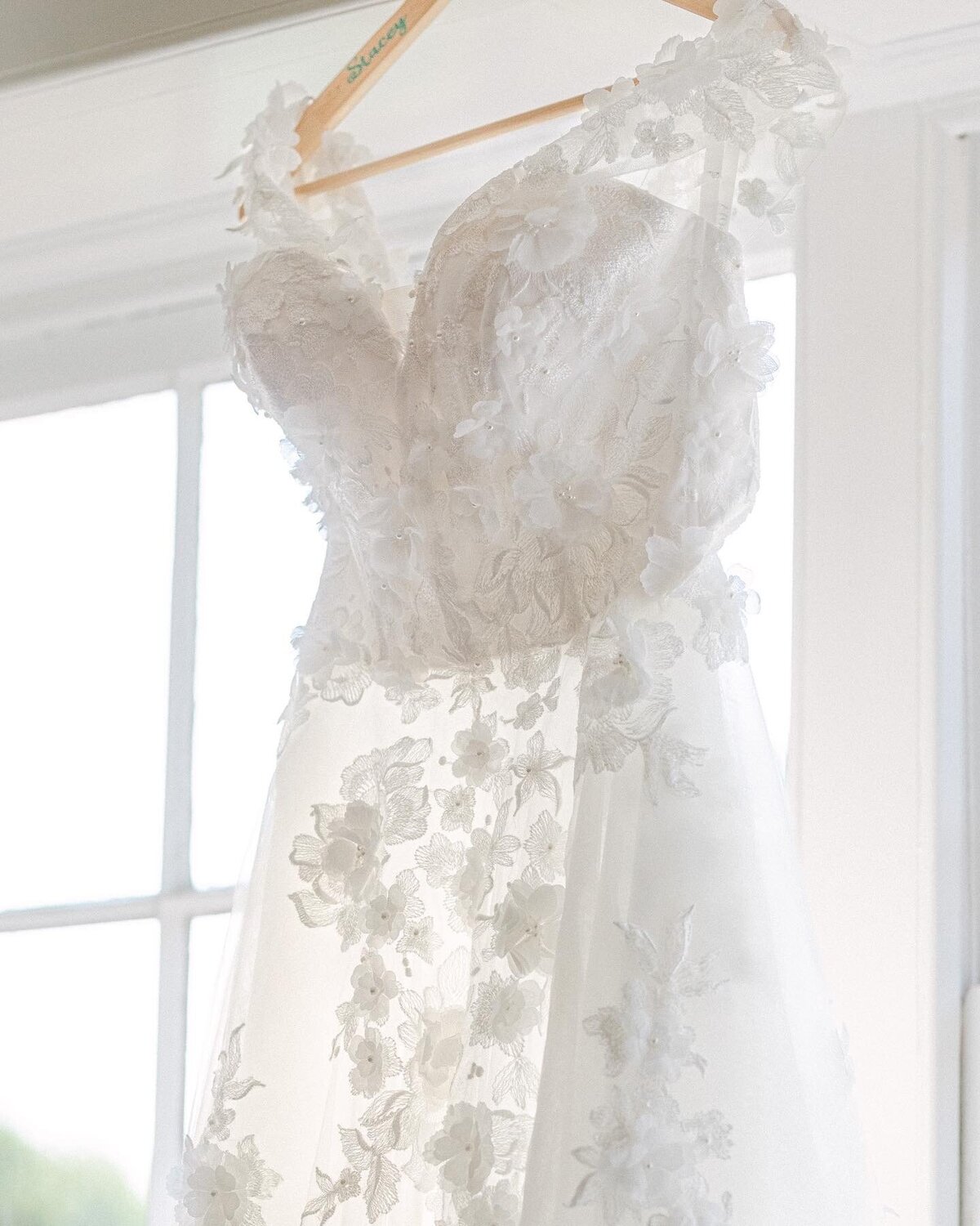 Details of the wedding dress hung in the window