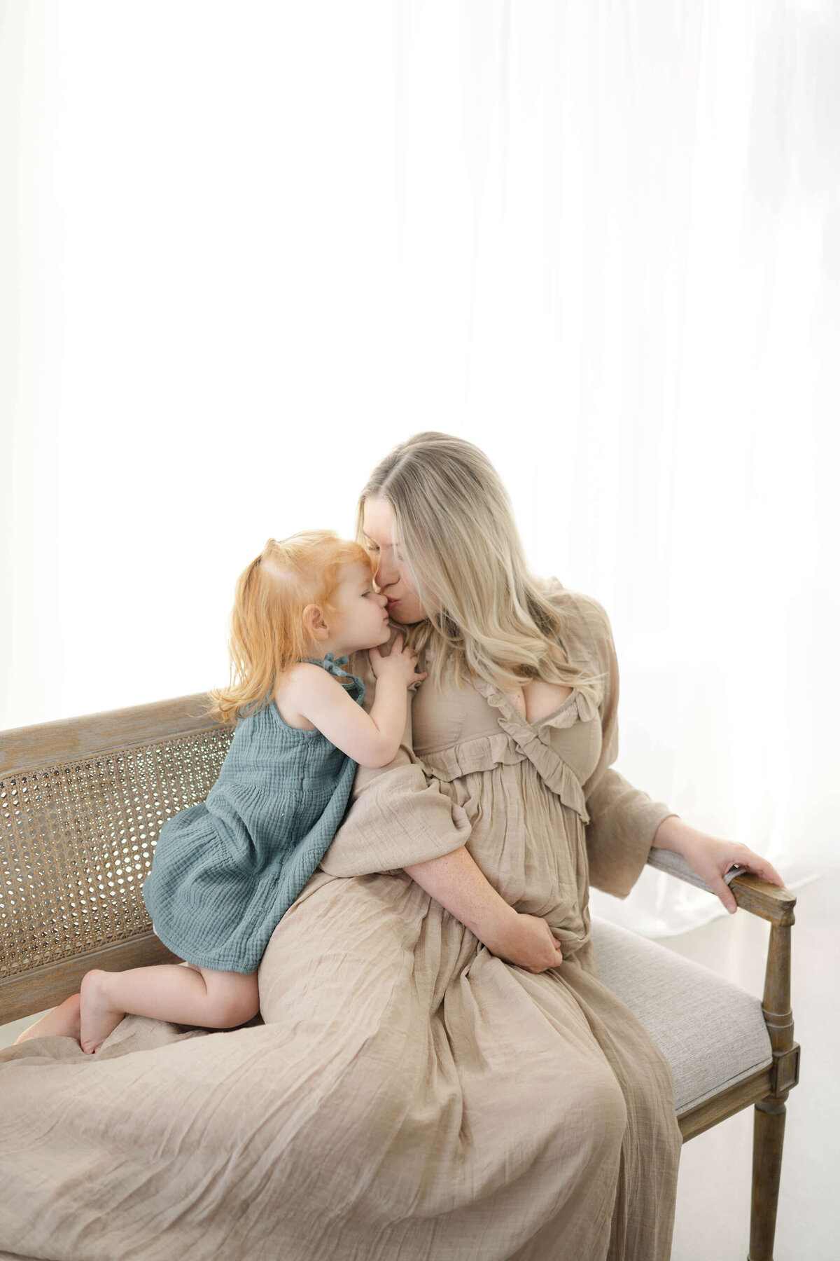 okc mom to be kissing her red head daughter