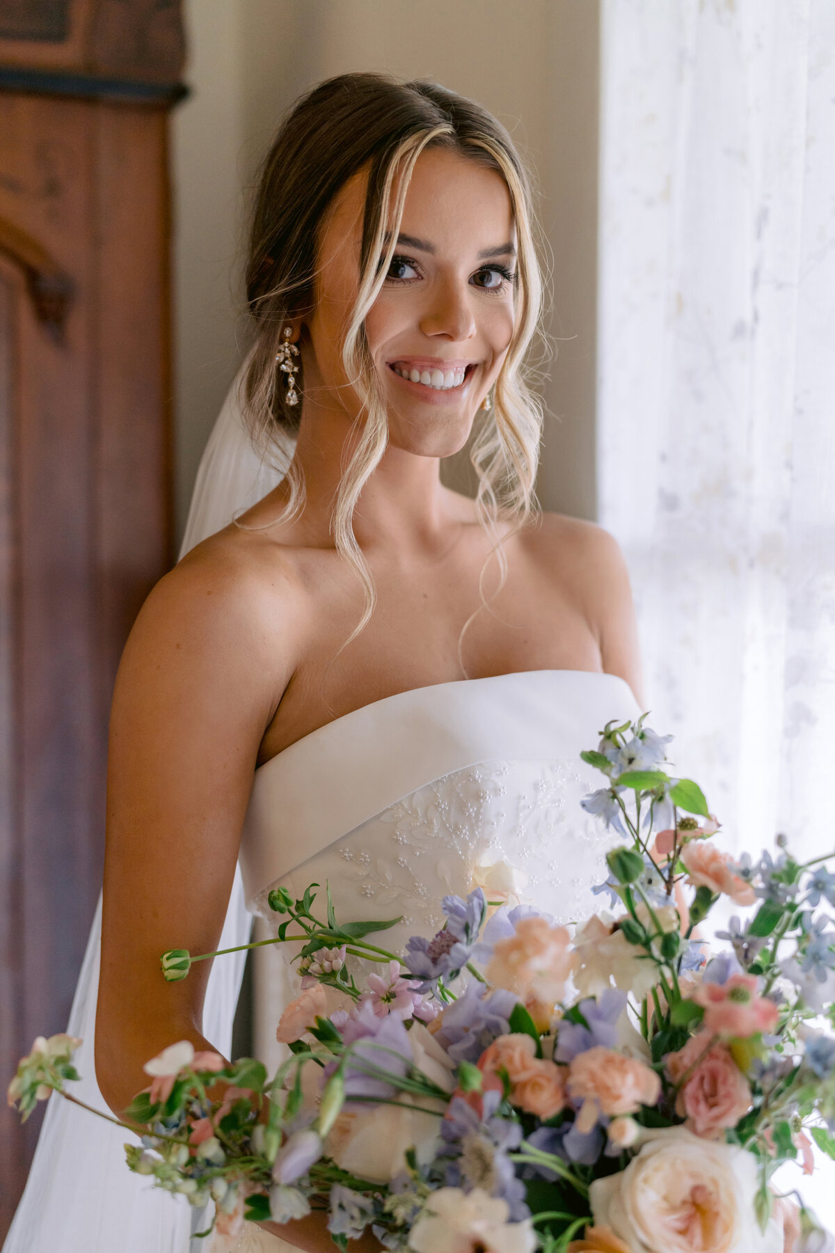Millennial bridal portrait holding organic wedding bouquet