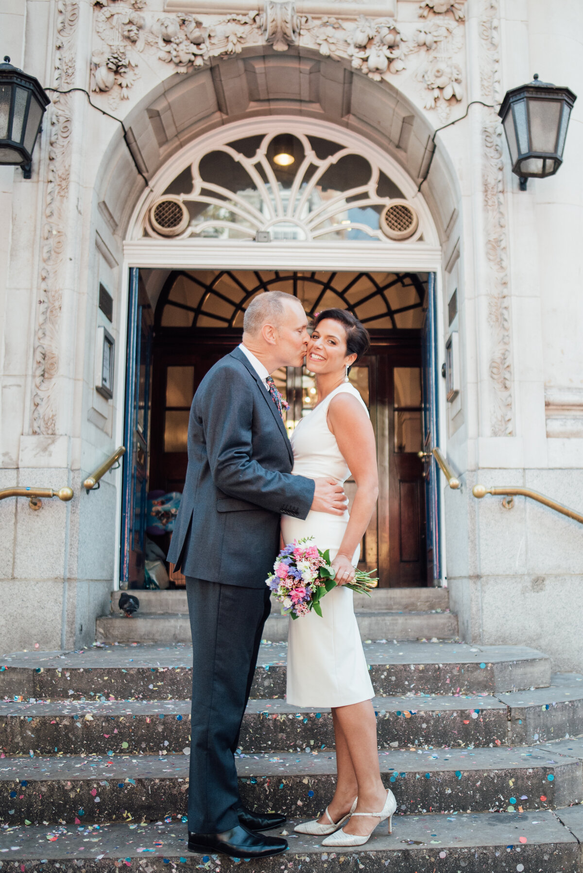 A couple sharing a kiss outside their wedding venue taken by London Wedding Photographer Liberty Pearl