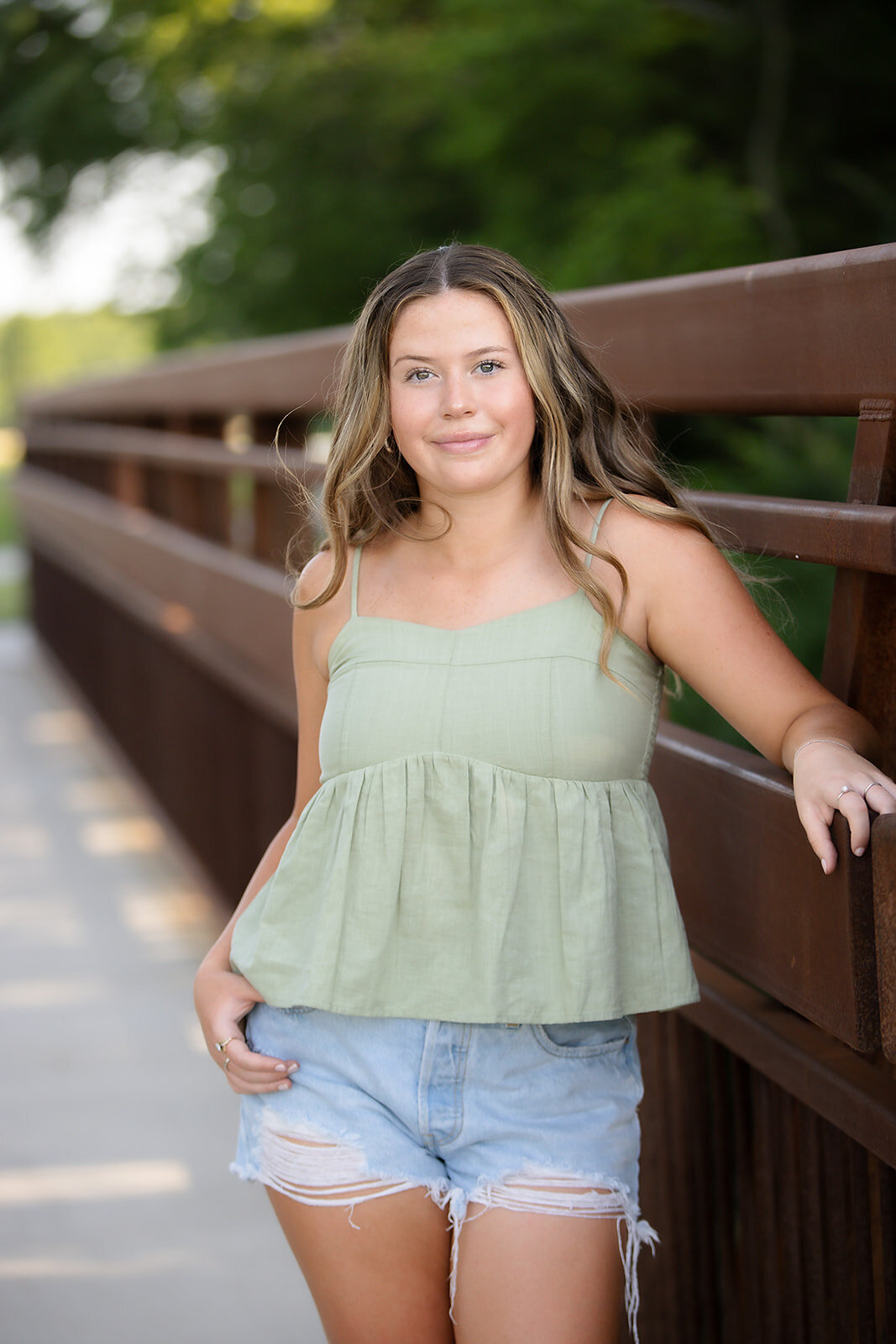Girl smiling while next to bridge
