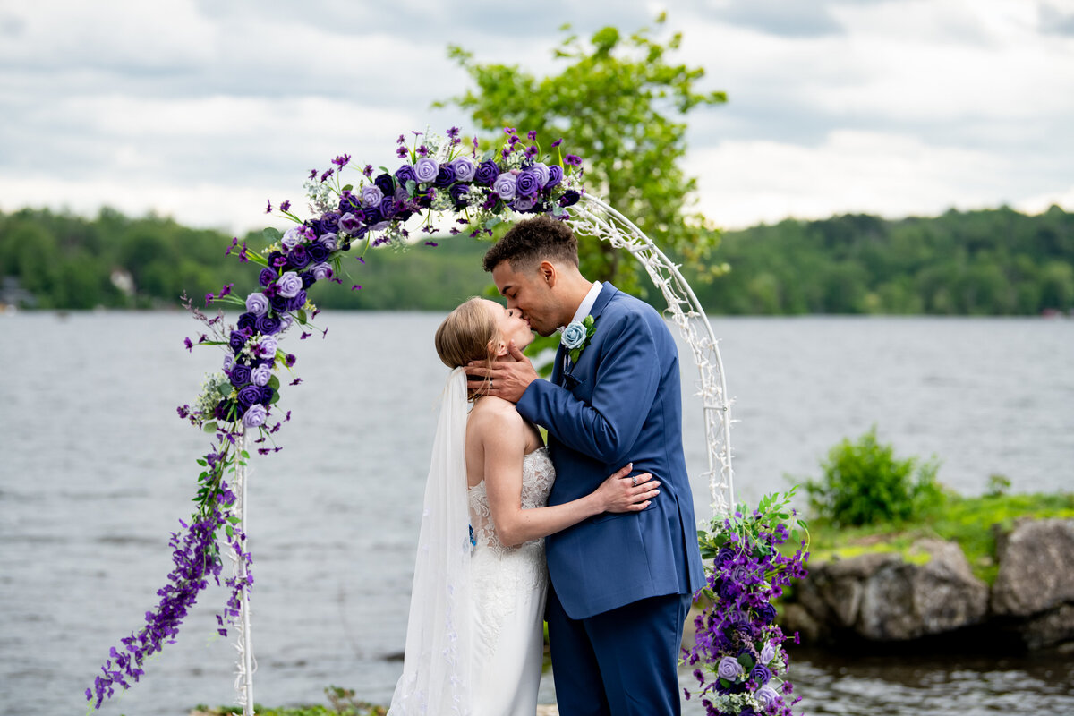 Couple standing under a blue sky on their wedding day at the North Shore House