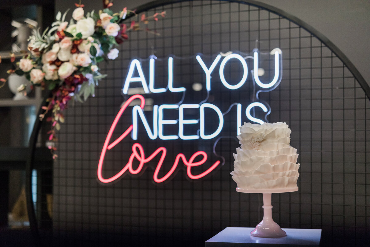 All you need is love neon sign by Stef Forward Events, trendy and modern decor rentals based in Calgary, AB. Featured on the Brontë Bride Vendor Guide.