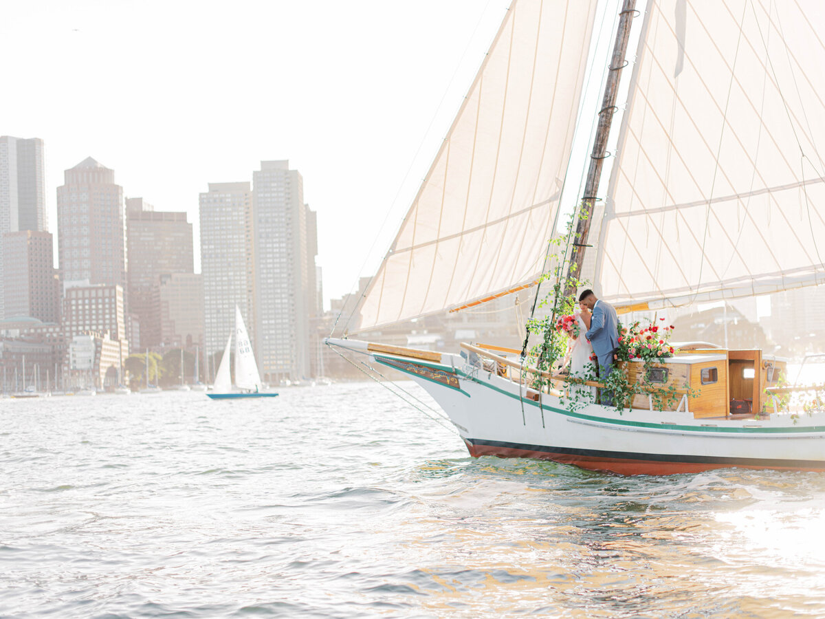 Kate-Murtaugh-Events-elopement-wedding-planner-Boston-Harbor-sailing-sail-boat-yacht-greenery-floral-installation-couple-bride-groom-water-skyline