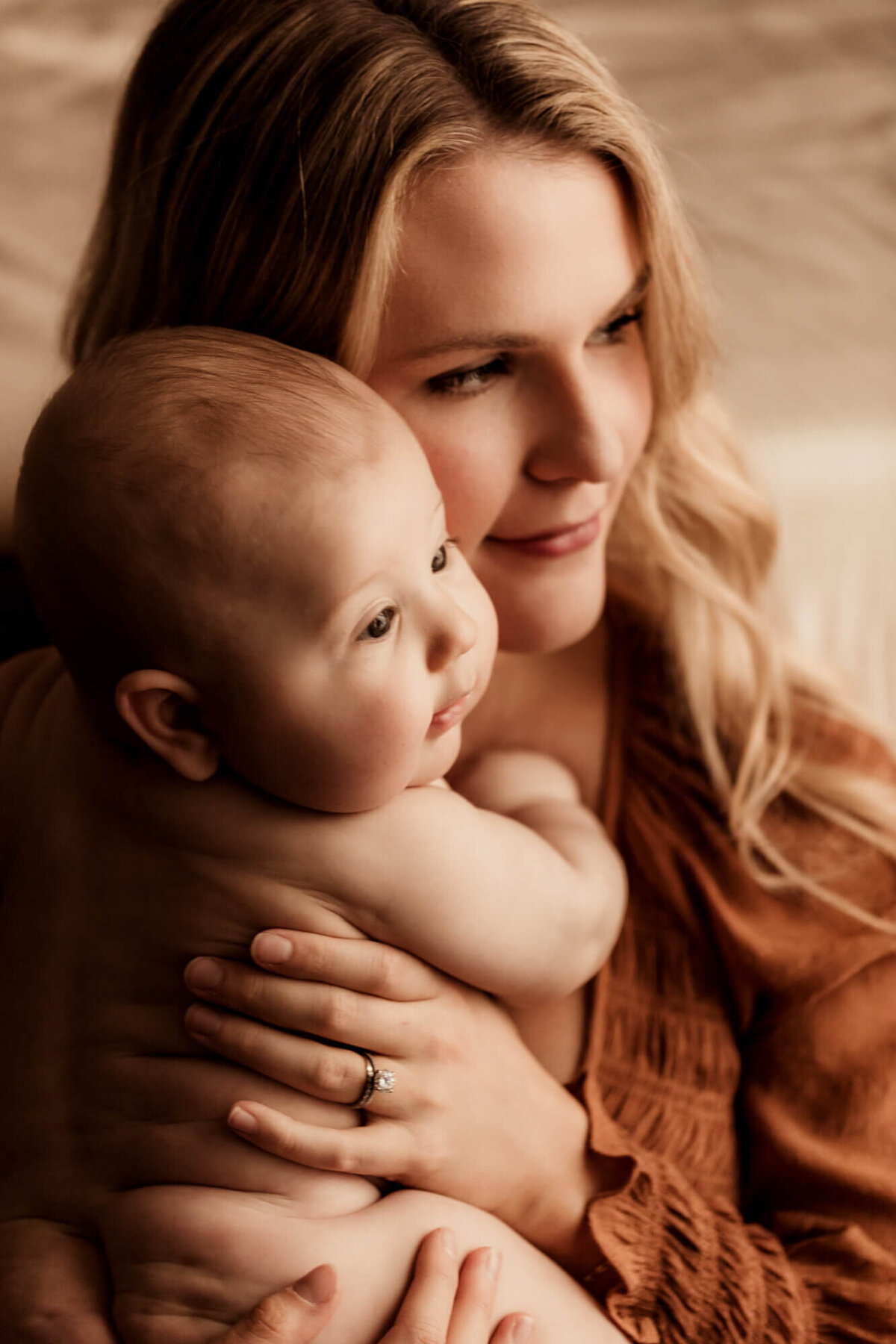 Mother holds her baby boy close to her for a studio photo in Tulsa, Oklahoma.