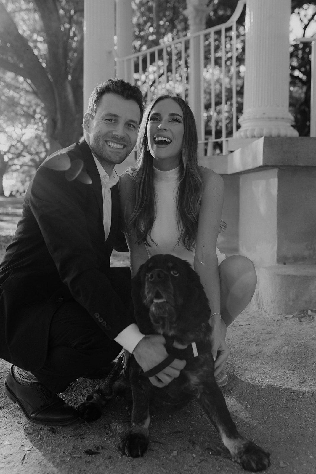 Couple with dog on engagement photo taken in White Point garden