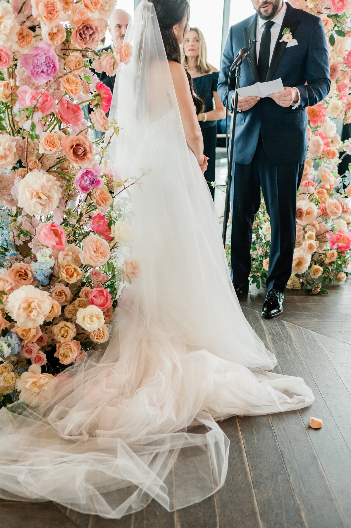 Bridge and groom stand at the altar exchanging vows 