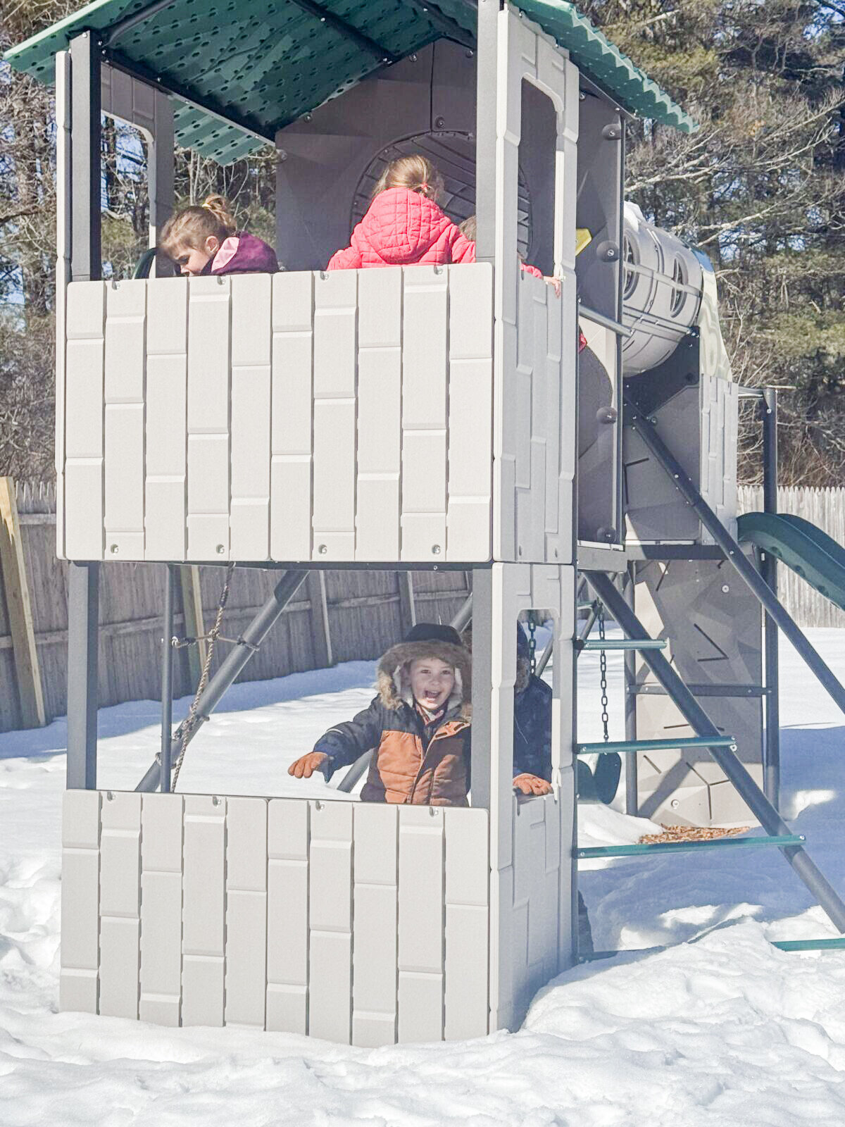 Students playing and laughing on the playground at House of Parker Preschool in Gorham Maine after they proudly put on their own winter gear, all by themselves!