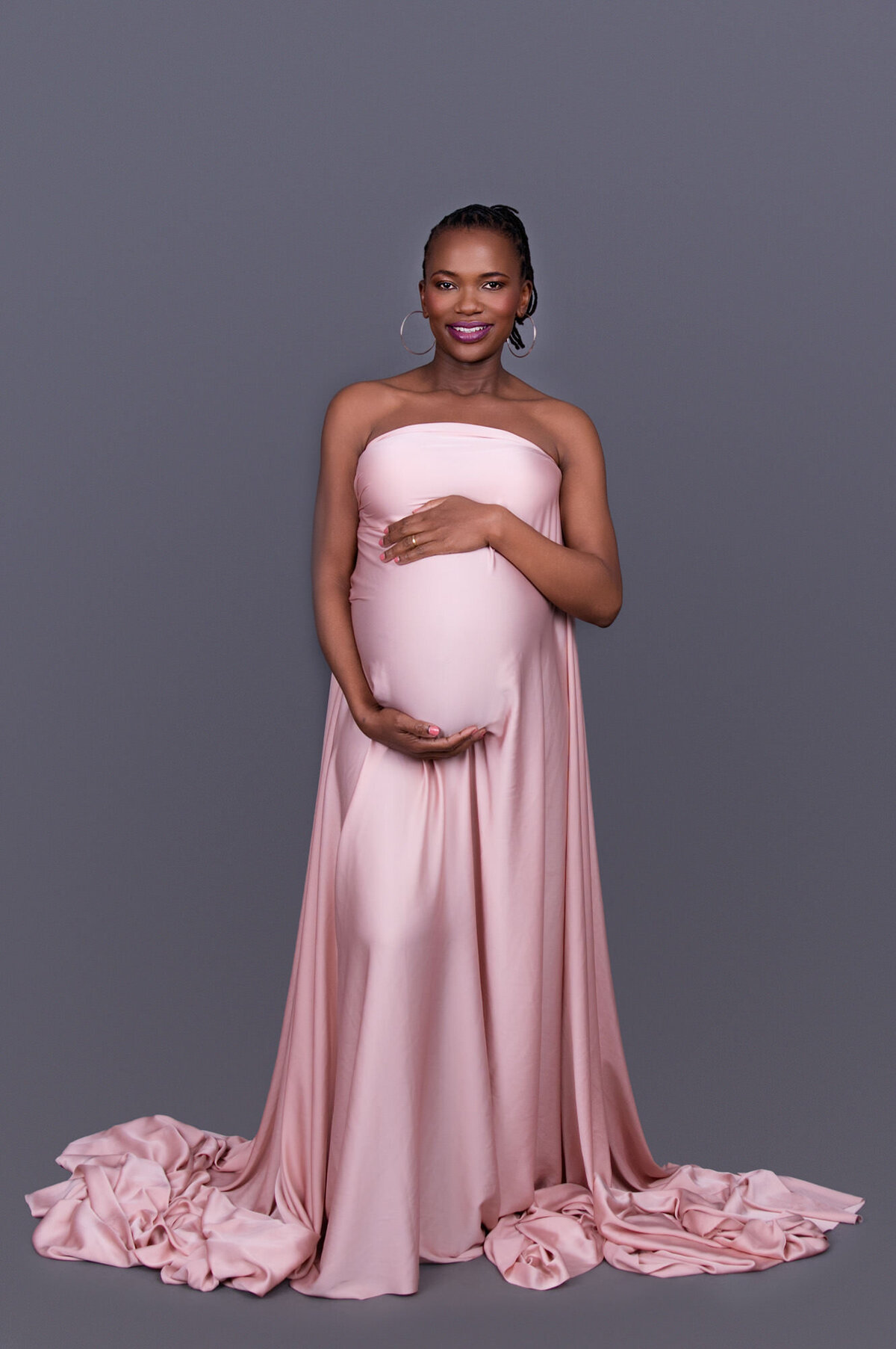 softly lit maternity portrait with flowing chiffon fabric.