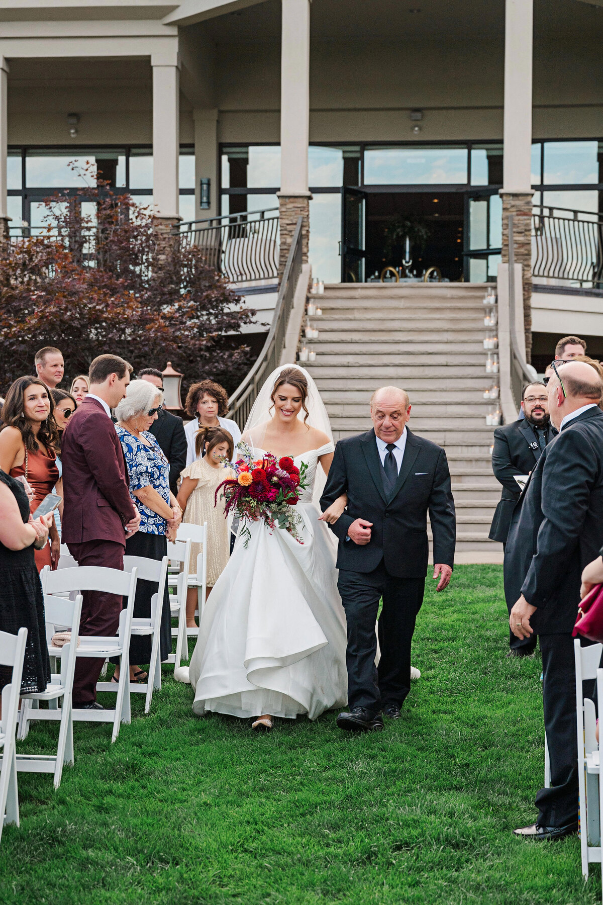 bride coming down the aisle at the lake club of ohio outdoor wedding ceremony