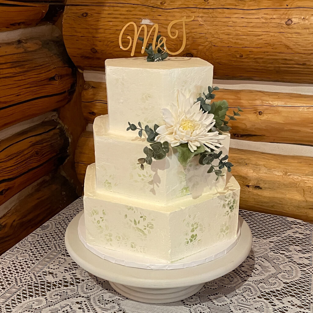 Hexagon snapped three-tiered elegant white wedding cake, created by Chartier YYC, elegant cakes & desserts in Calgary, AB, featured on the Brontë Bride Vendor Guide.