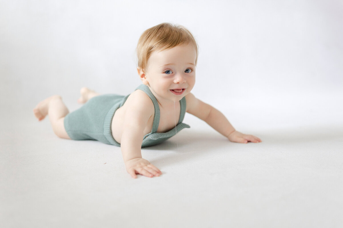 Tampa 6-month milestone portrait of smiling baby boy in natural light studio