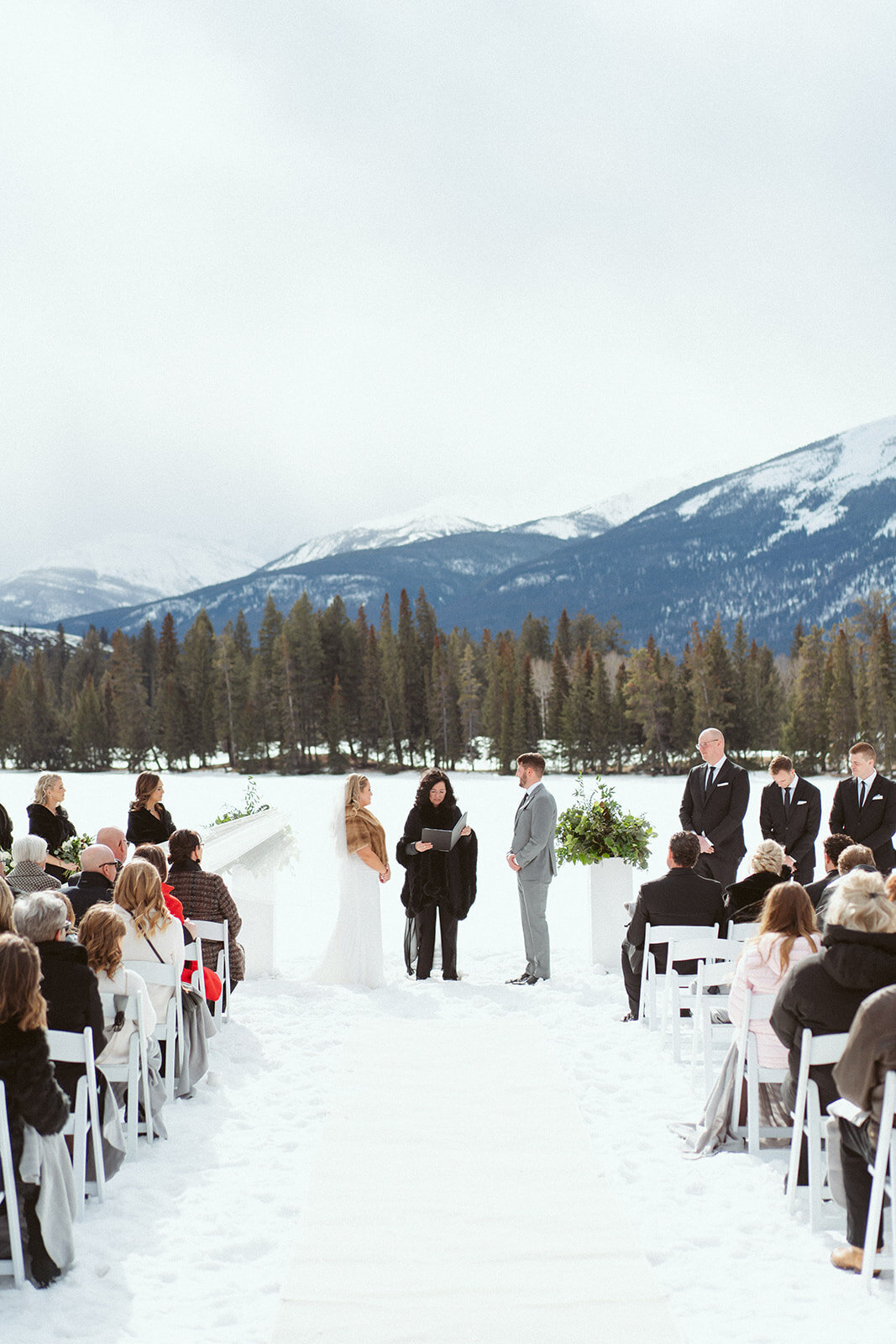 Bride and groom saying their vows in outdoor mountain wedding.