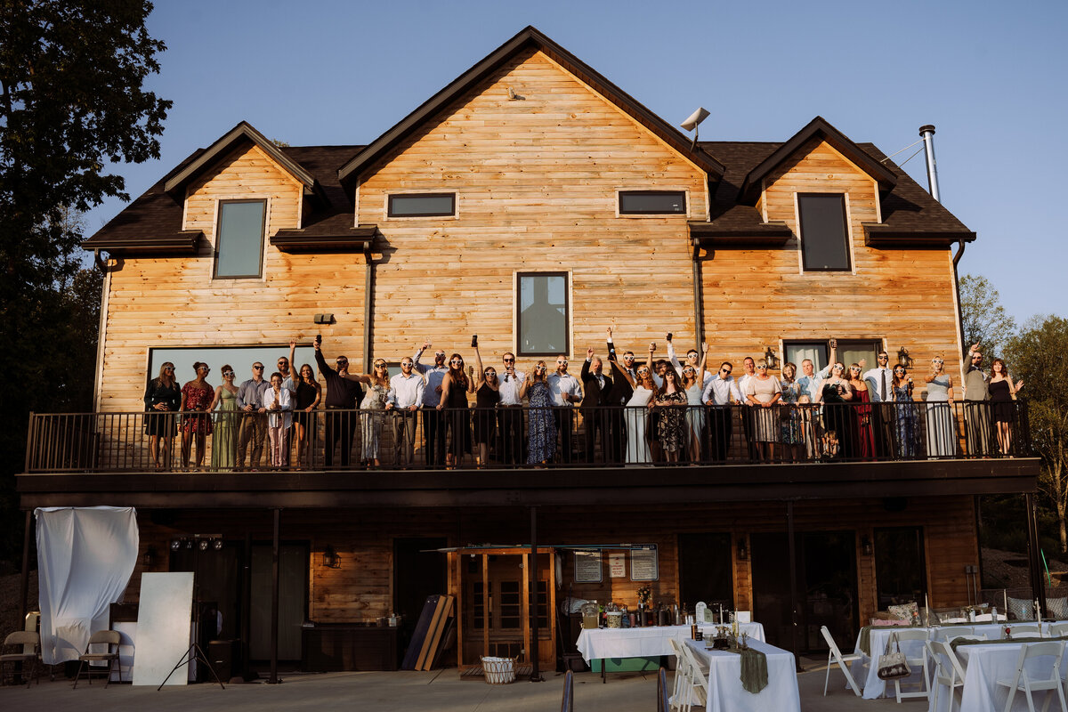 wedding guests on the deck of a house