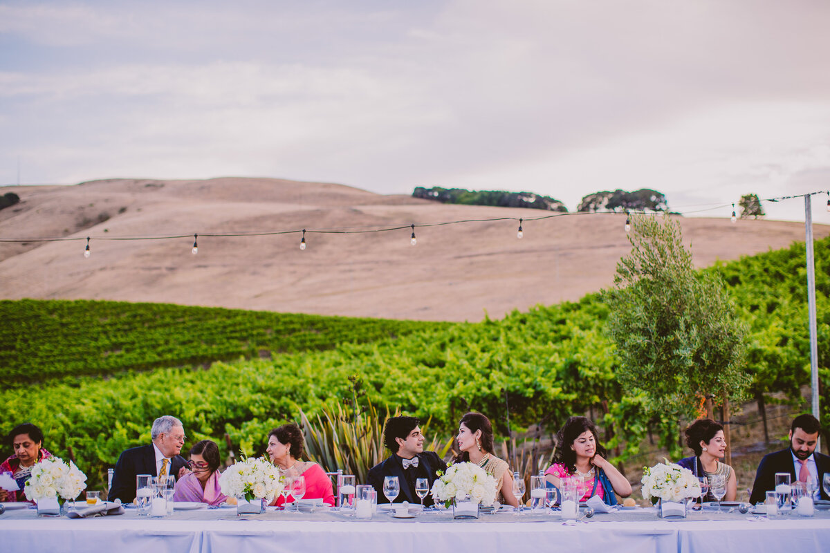 indian bride and groom having dinner at their wedding reception in sonoma county california at glasshouse vineyards