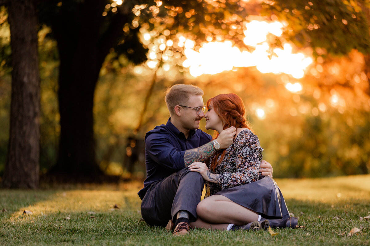 A couple shares cuddles at a park during sunset at Delwood Park.
