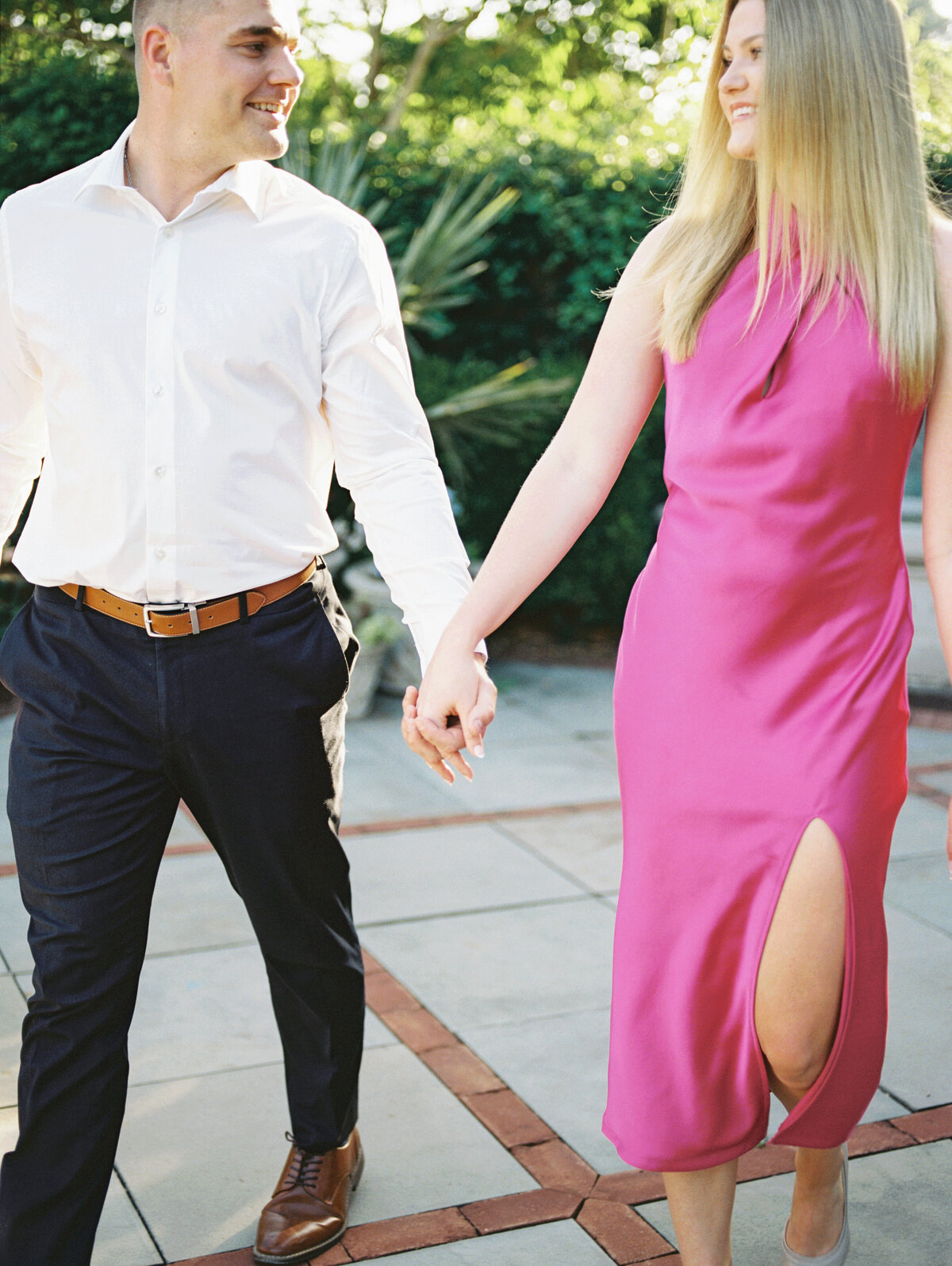 Close-up of couple walking away from stone fountain in Columbus park shot by Philadelphia wedding photographer.