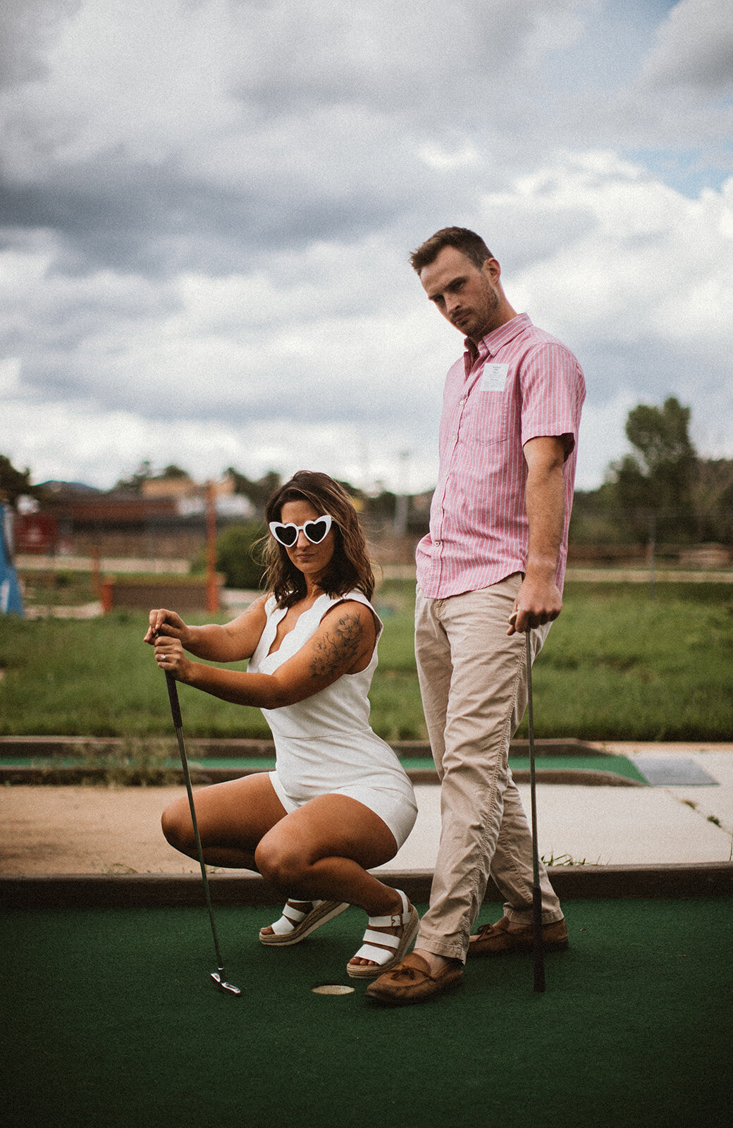 engaged couple at a mini golf course