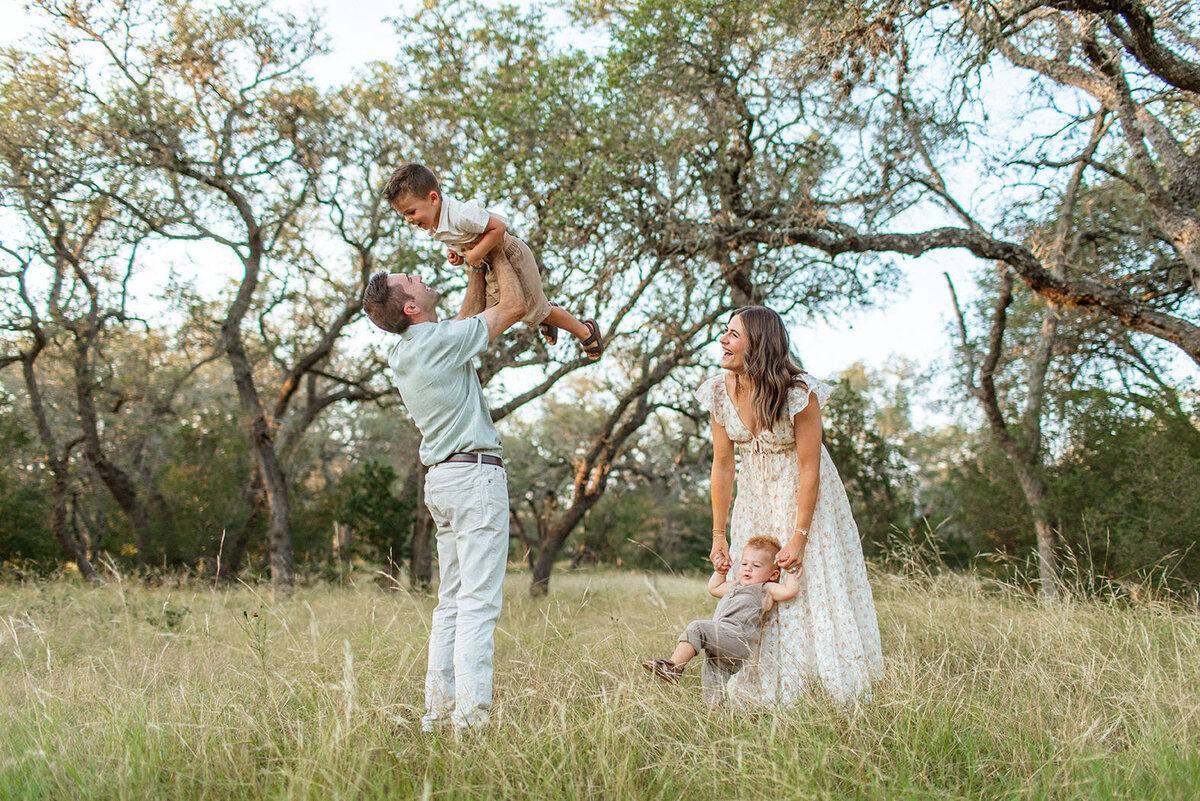 Candid outdoor photos of a family playing together, photographed by Sara James, a San Antonio family photographer.