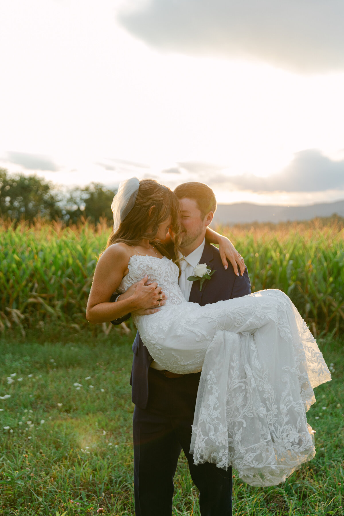 groom-carrying-bride-golden-hour