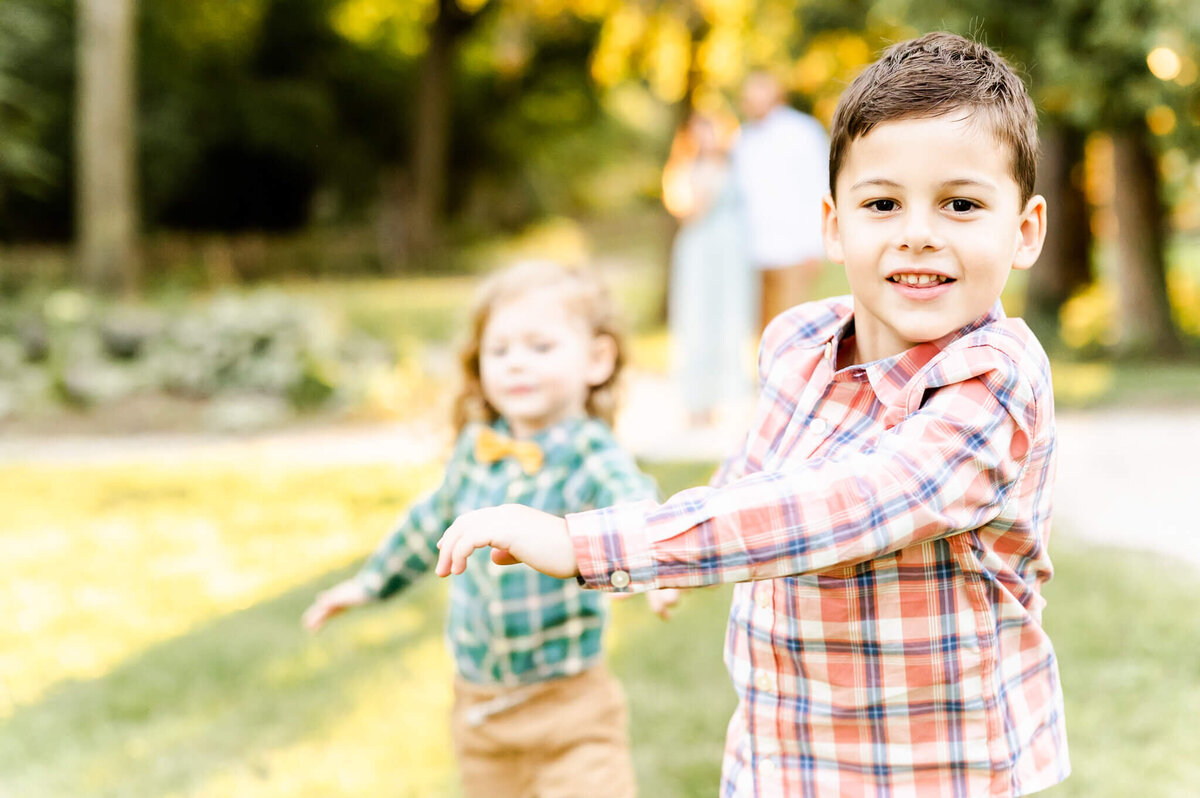 Boys running at camera during a family session near Naperville, IL.