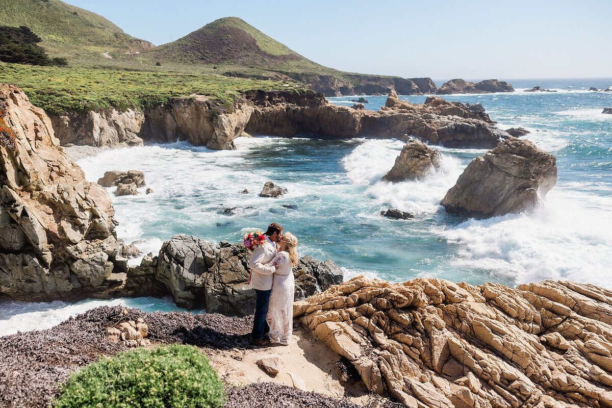 The bride and groom kiss at Garrapata State beach during their elopement.