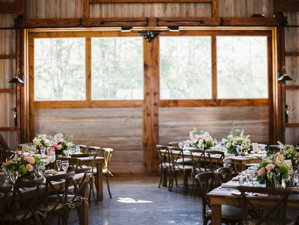 Wooden tables and chairs with floral centerpieces
