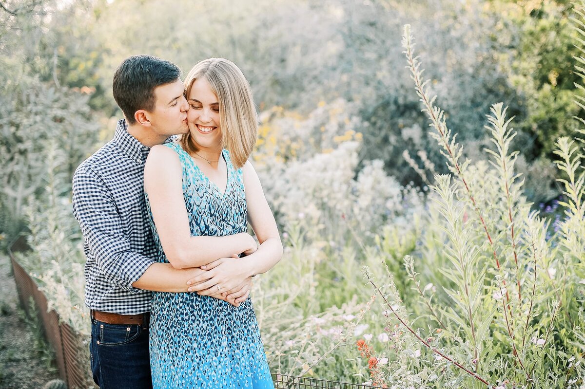 engaged-couple-kissing-at-desert-botanical-garden