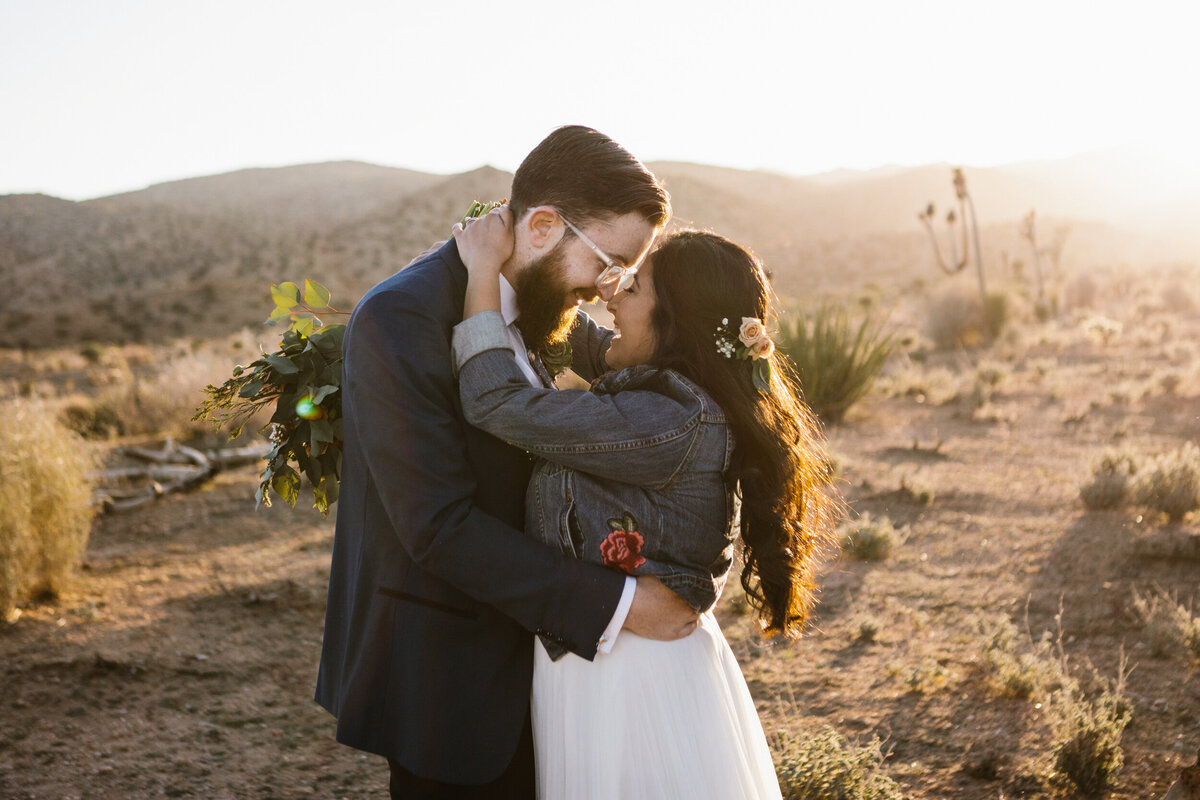 bride and groom embrace during sunset