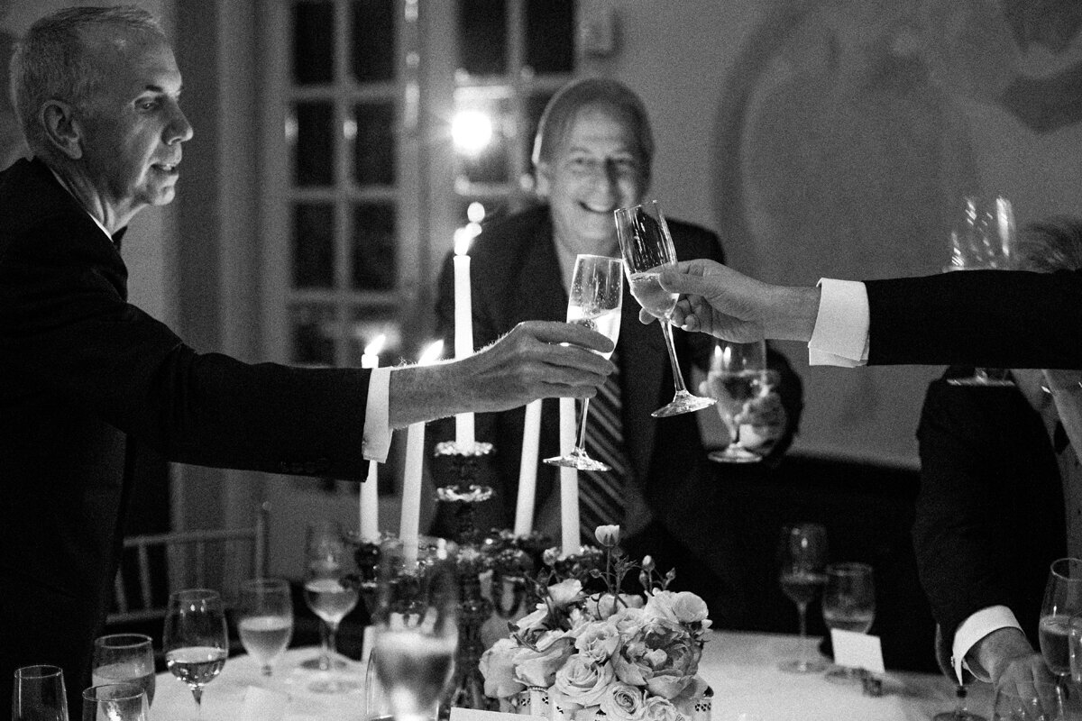 People toasting at wedding photo in black and white