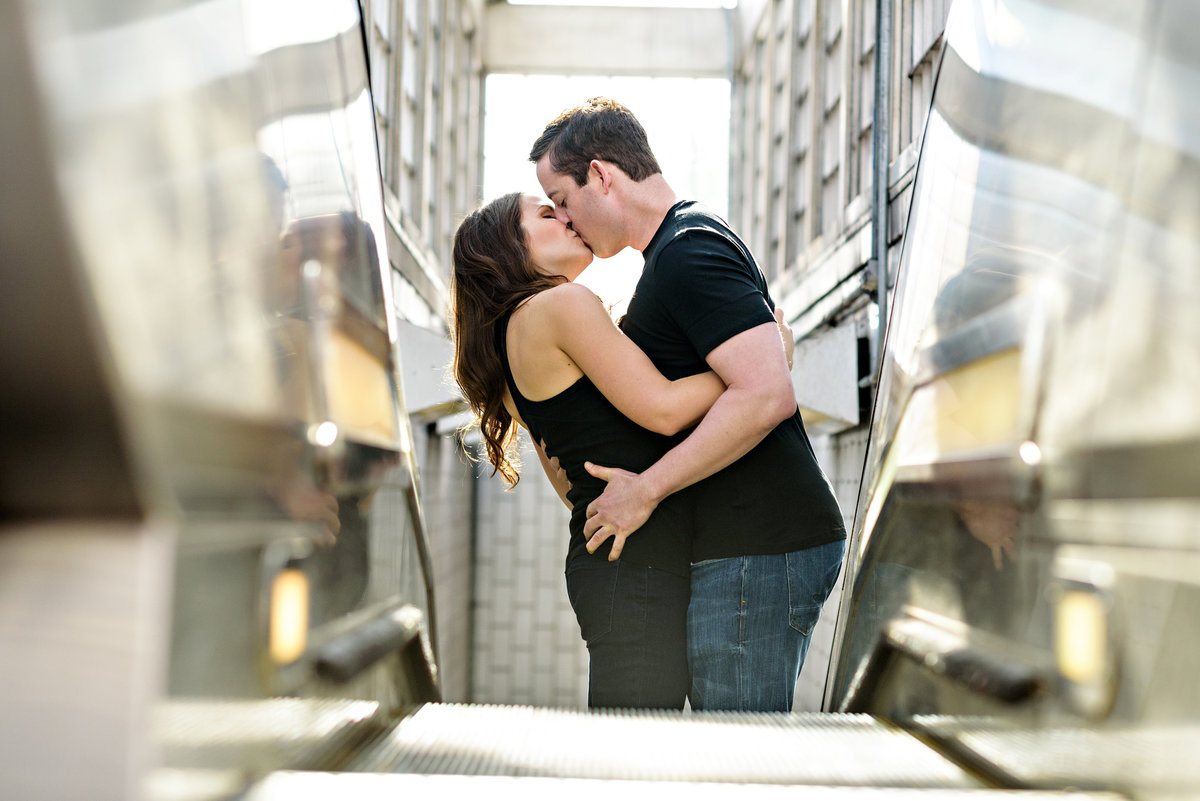 A kissing couple ride the escalator all the way to the top.