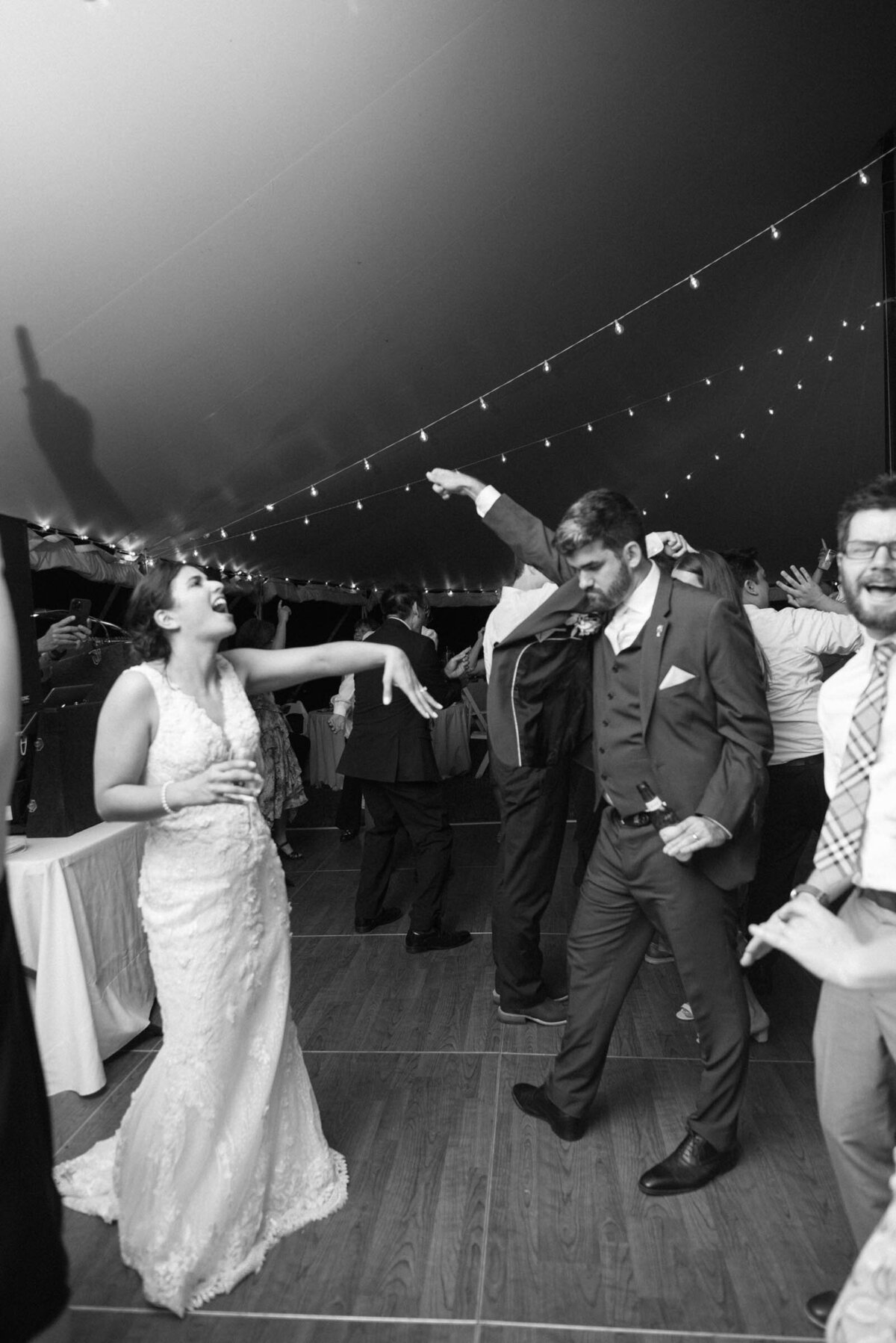 guests dancing under tented reception in boston wedding venue connors center