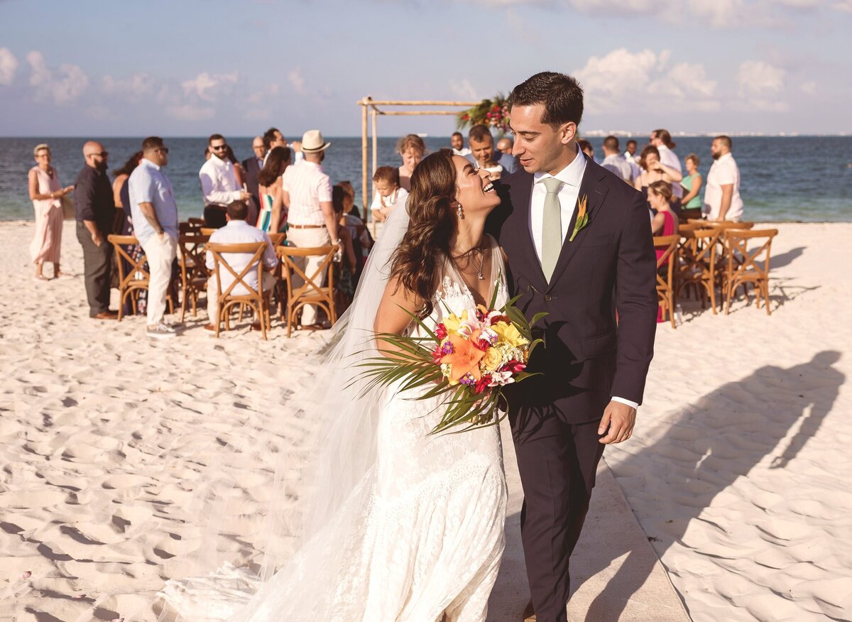 Bride and groom laughing with each other after wedding in Cancun