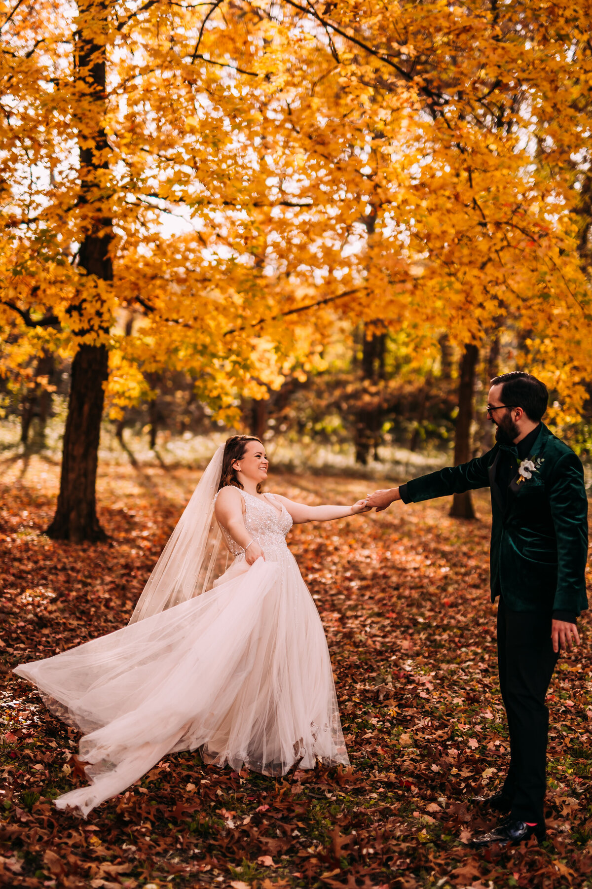 bride and groom dancing in Forest Park in the fall orange leaves