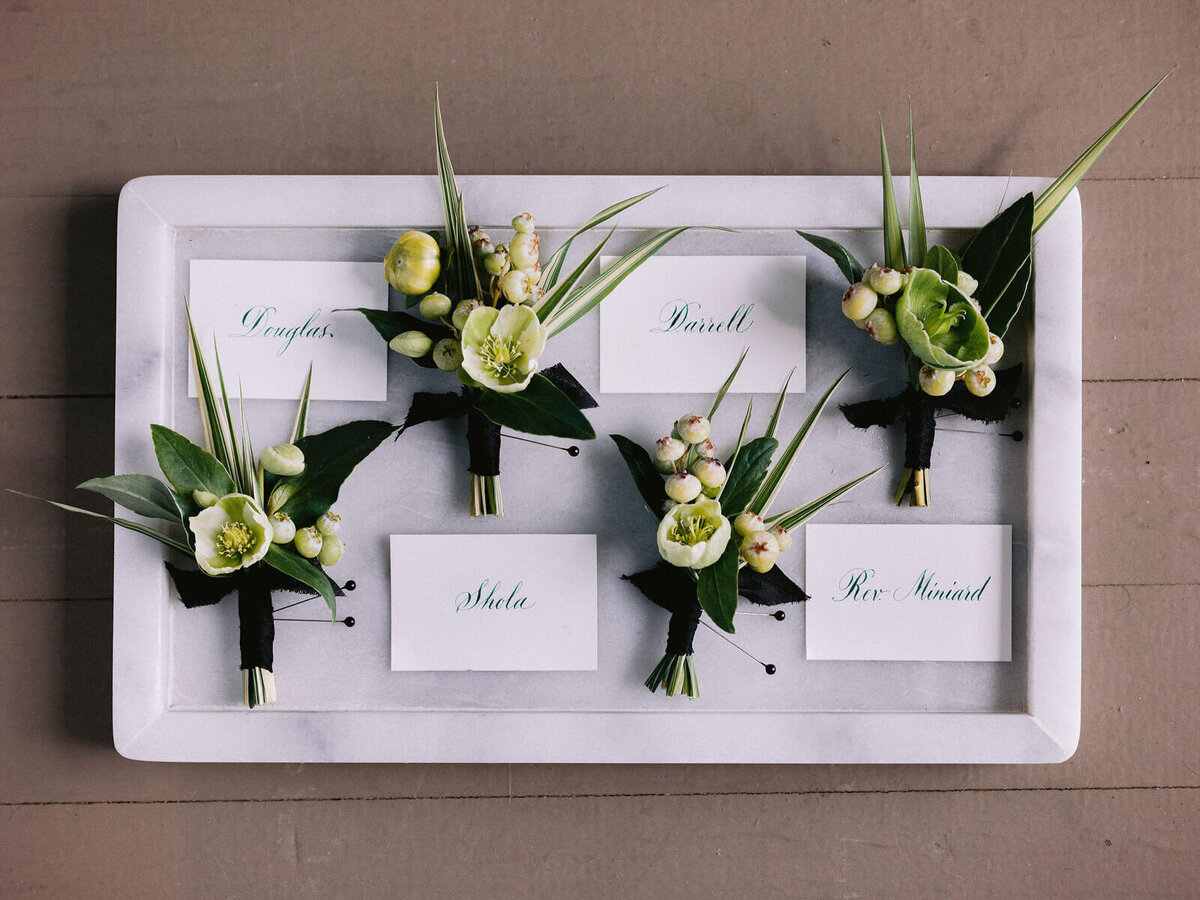 Name cards and boutonnieres in Montage at Palmetto Bluff. Destination wedding image by Jenny Fu Studio